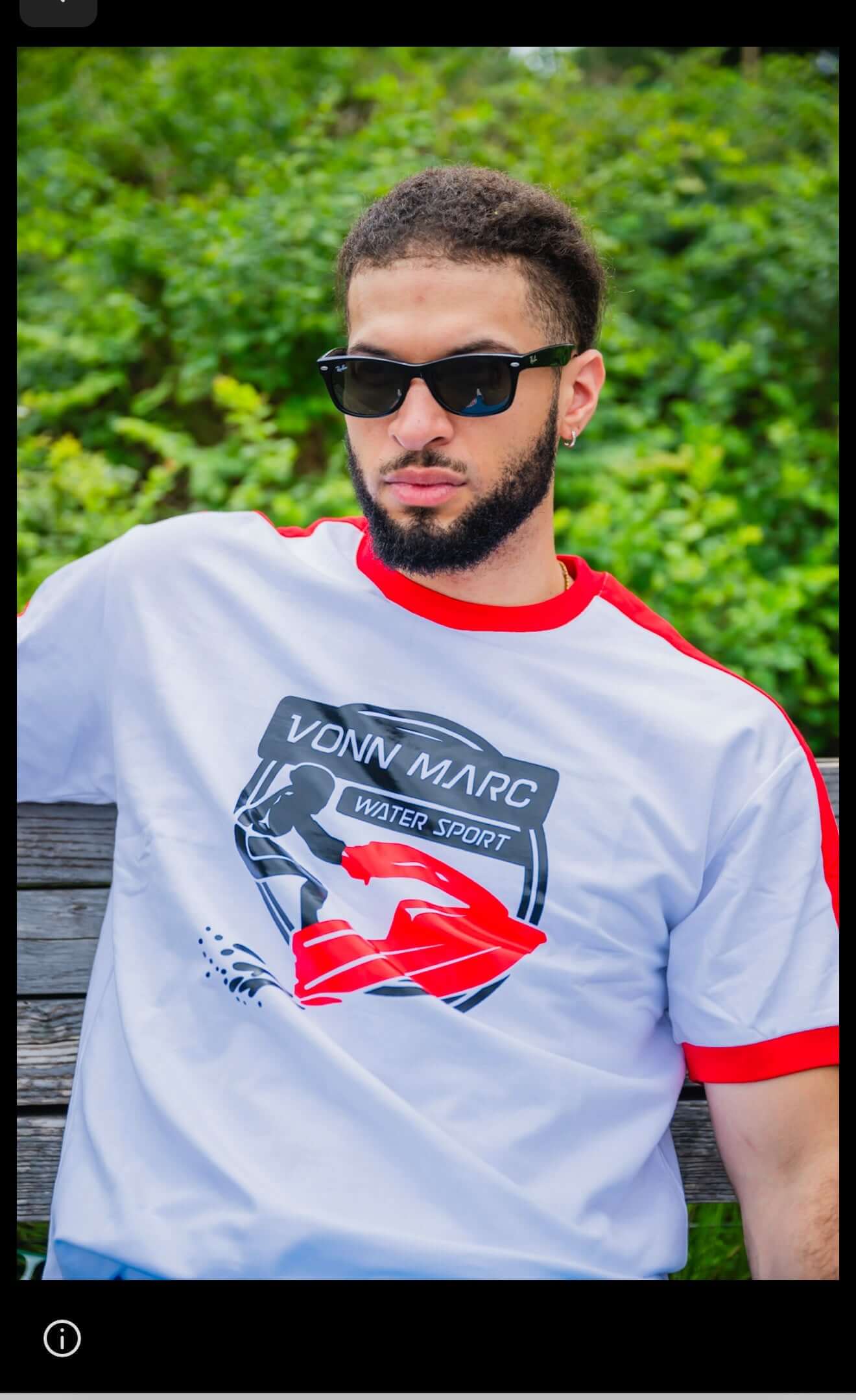 Model wearing VONN MARC T-SHIRT with bold graphics and red accents in a natural outdoor setting.